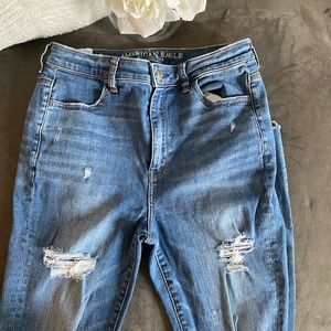 Medium wash distressed super high rise jeans